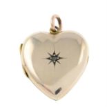 An early 20th century gold heart-shape locket, with rose-cut diamond highlight.