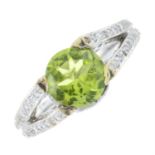 A peridot and diamond dress ring.