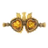 A late Victorian 9ct gold yellow paste twin hearts and thistle brooch.