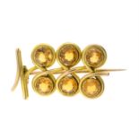 An early 20th century 9ct gold citrine stylised fruit brooch.
