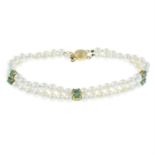 A cultured pearl two-row bracelet, with emerald and diamond spacers.