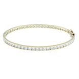 A 9ct gold cubic zirconia bangle.