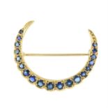 An early to mid 20th century 9ct gold sapphire crescent moon brooch.