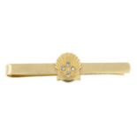 A 9ct gold shell tie slide, with diamond highlights.