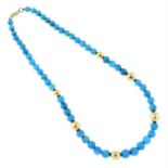 A graduated turquoise bead single-strand necklace, with hollow bead spacers.