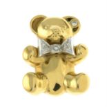 A teddy bear brooch, with brilliant-cut diamond bow and ear accents, by Leo Wittwer.