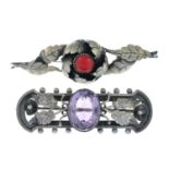 An Arts and Crafts silver amethyst brooch, together with a further red gem brooch.