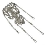 A silver ornate chatelaine with floral and cherub motif and four chain clips.