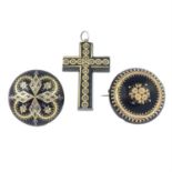 Two tortoise shell pique brooches and cross pendant.