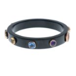 A vari-cut multi-gem black plastic bangle.