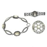 A small selection of Scottish jewellery to include two silver openwork gem-set brooches,