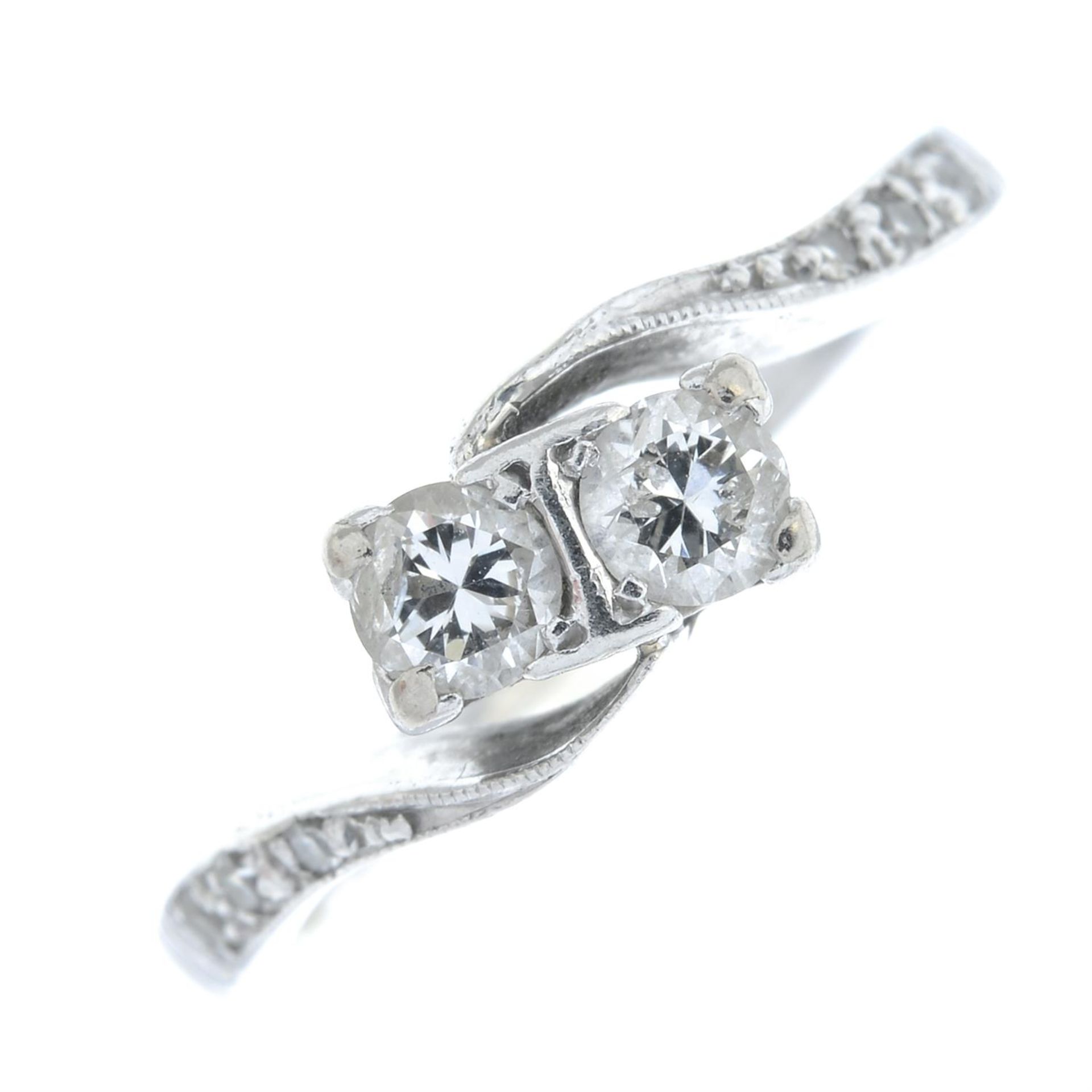 A brilliant-cut diamond crossover ring, with old-cut diamond shoulders.