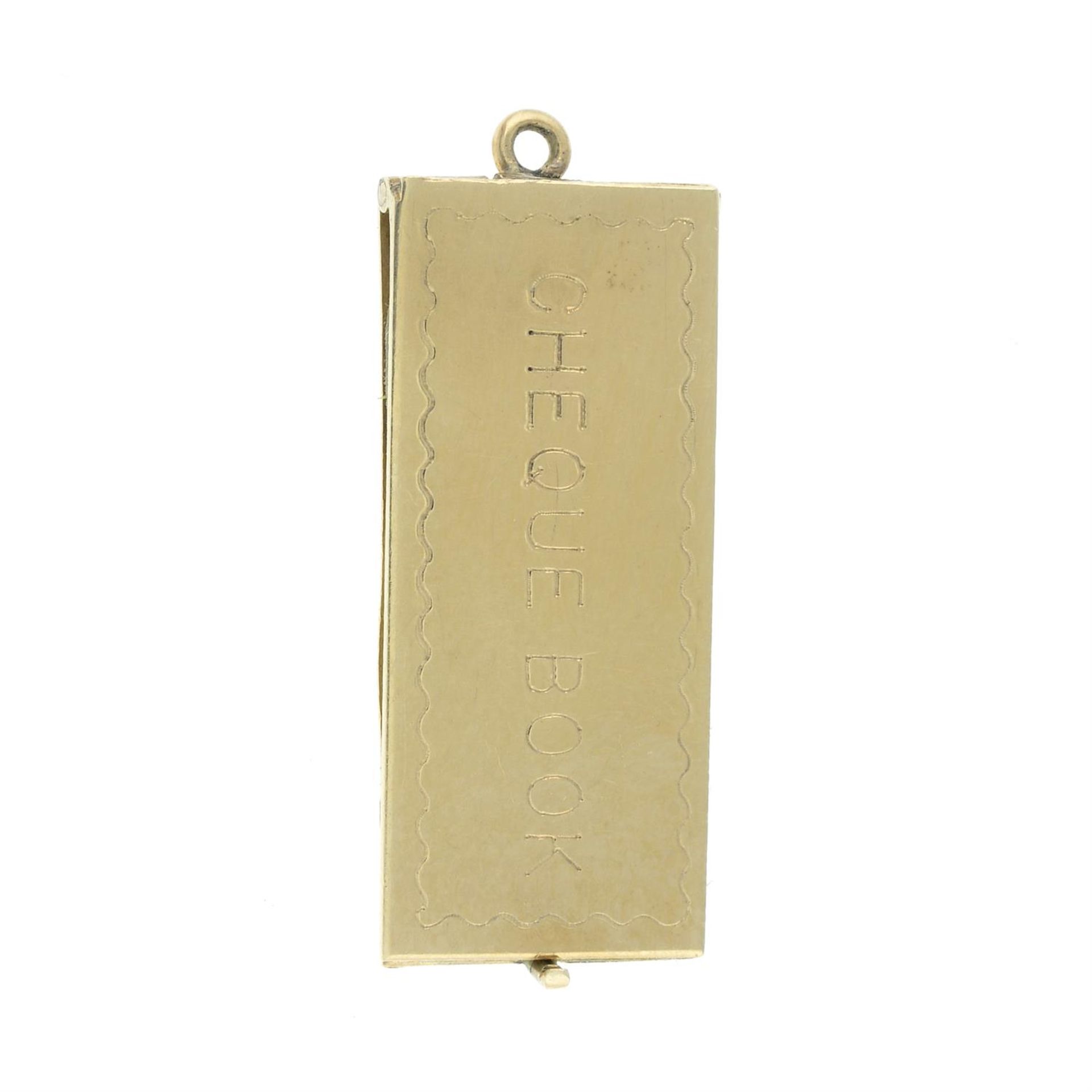 A late 20th century 9ct gold cheque book charm.