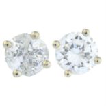 A pair of brilliant-cut diamond stud earrings.