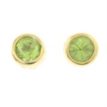 A pair of peridot single-stone stud earrings.