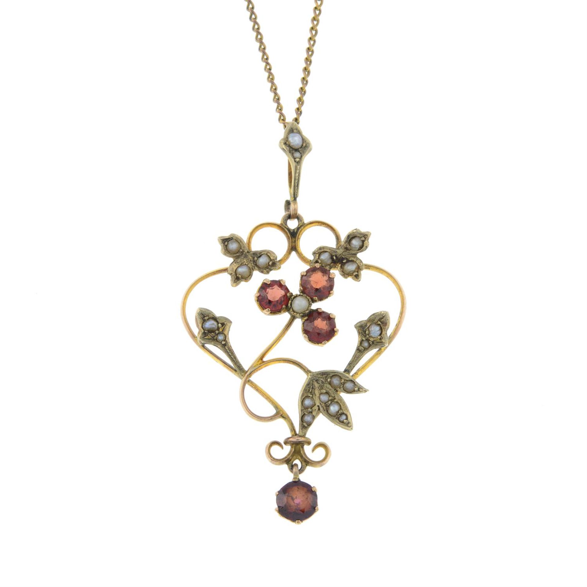 An early 20th century 9ct gold garnet and split pearl openwork pendant, with trace-link chain.
