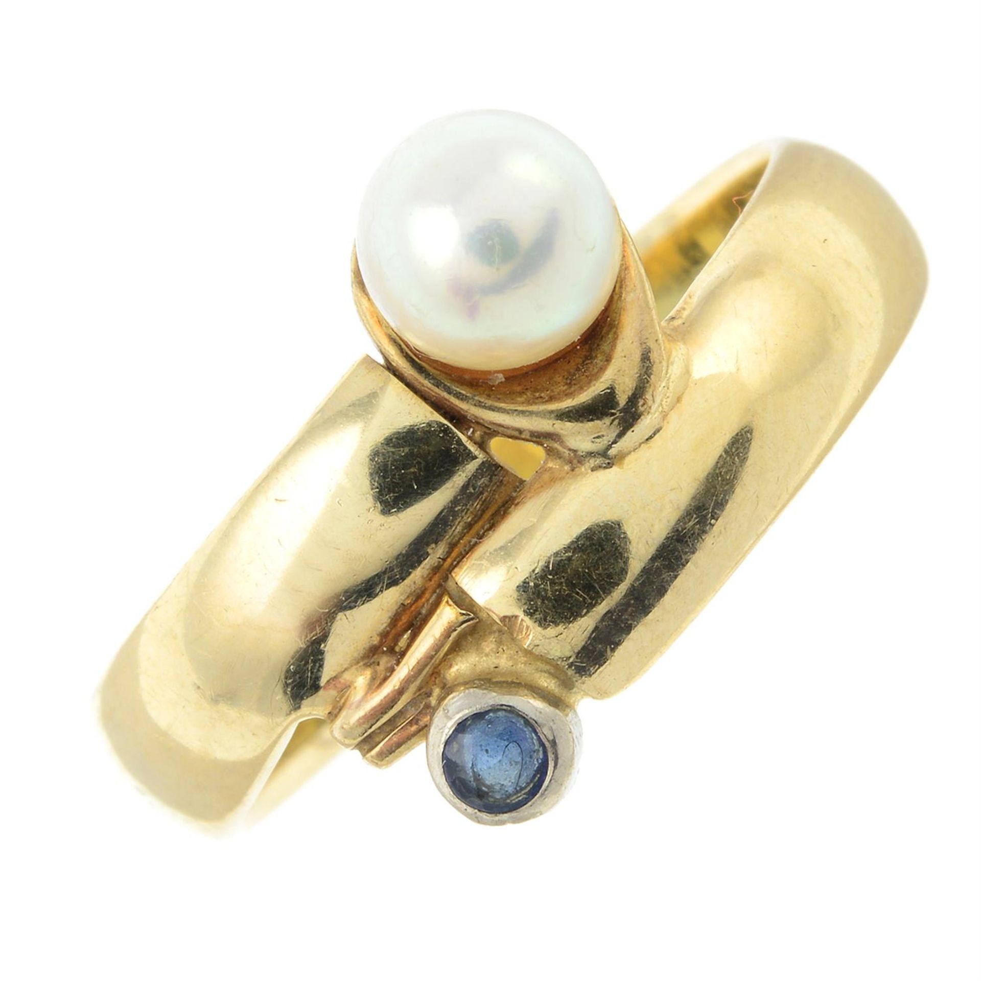 A sapphire and cultured pearl crossover ring.