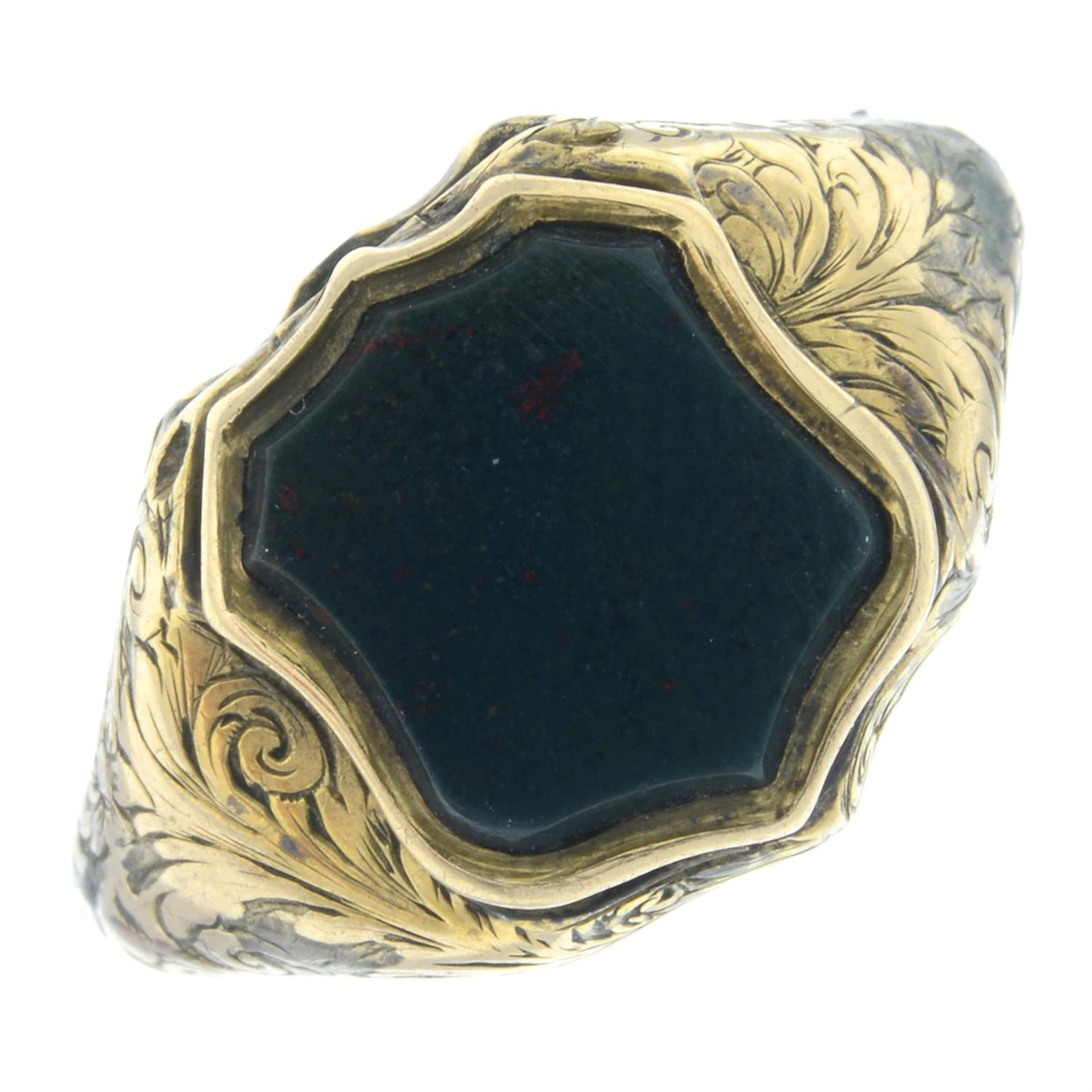 A 19th century shield-shape bloodstone signet ring, with locket compartment.