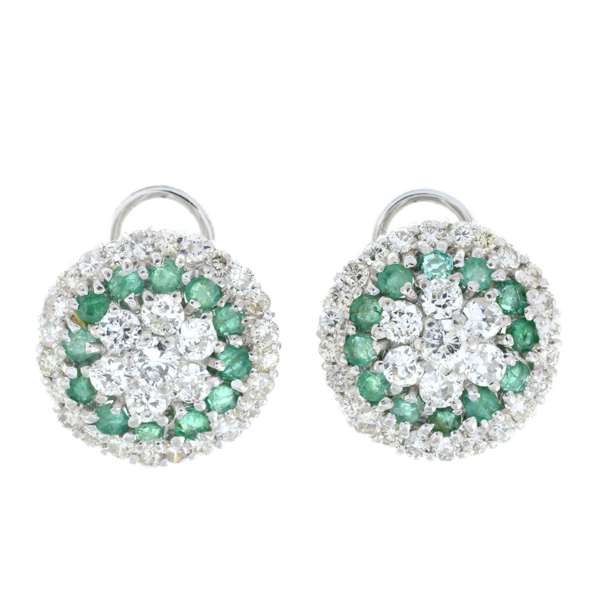 A pair of emerald and brilliant-cut diamond cluster earrings.