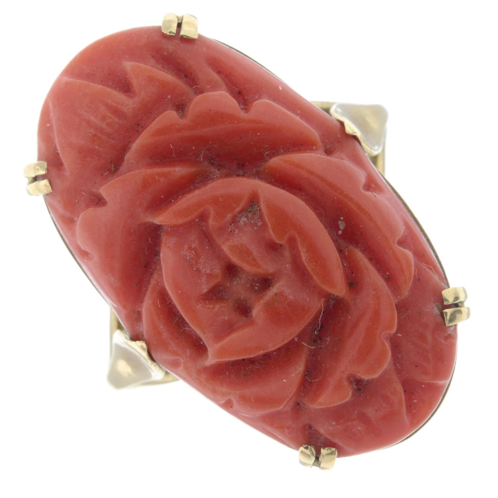 A coral single-stone dress ring, carved to depict a rose.