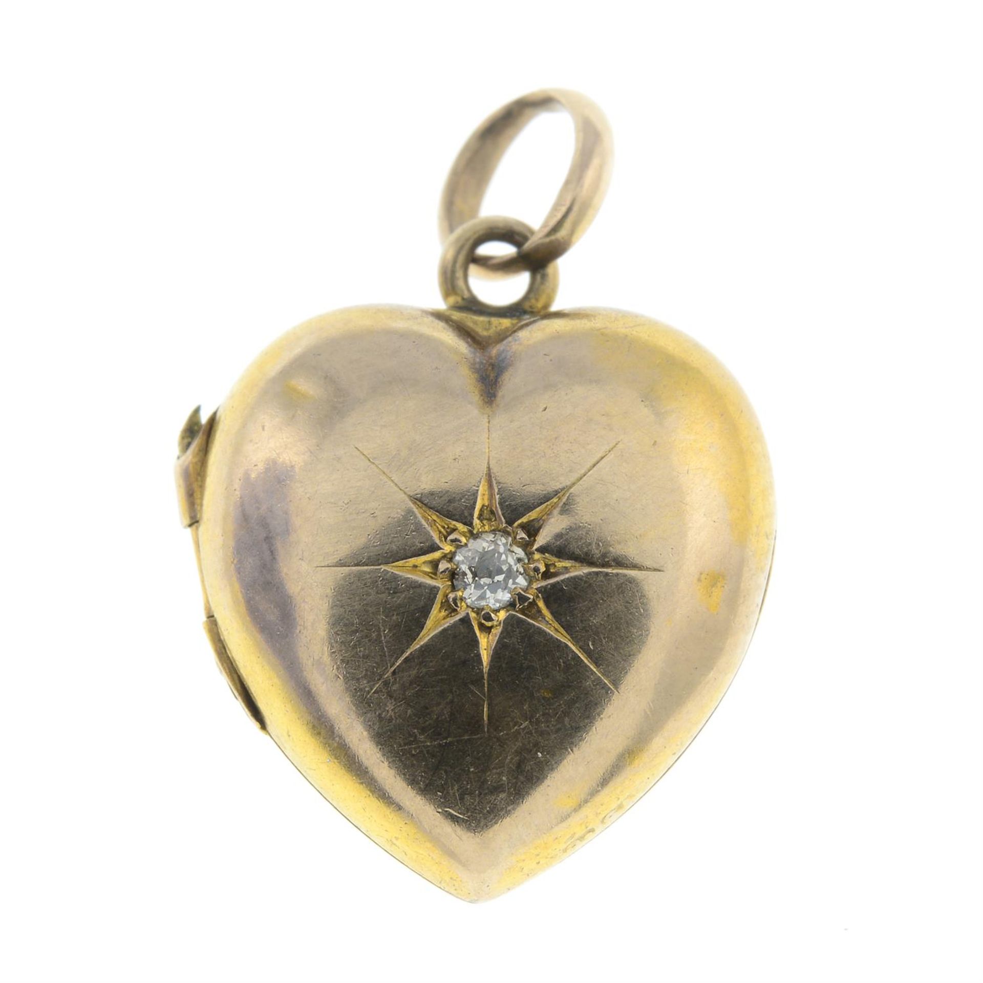An early 20th century gold old-cut diamond heart-shaped locket charm/pendant.