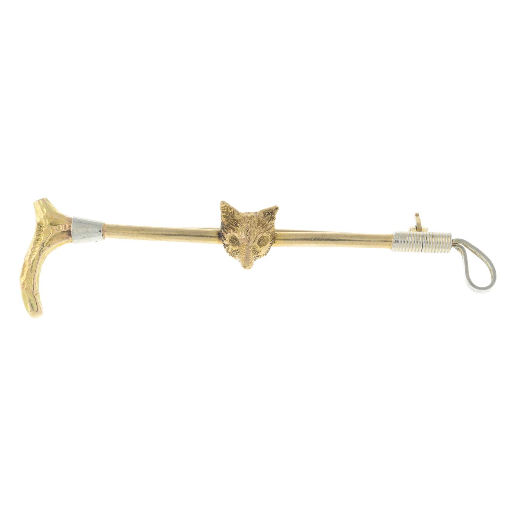 An early 20th century 9ct gold fox head and riding crop bar brooch.