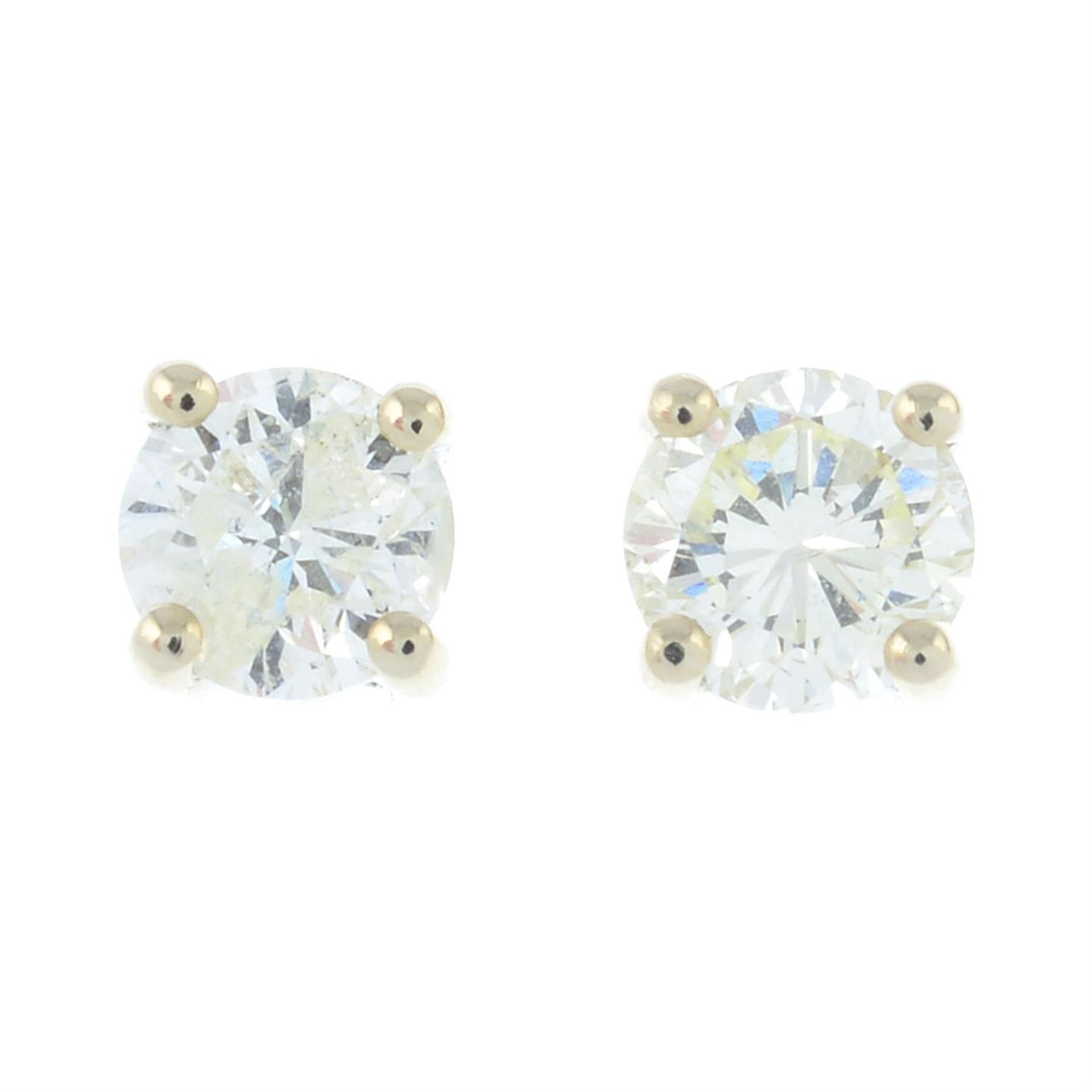 A pair of brilliant-cut diamond single-stone stud earrings.