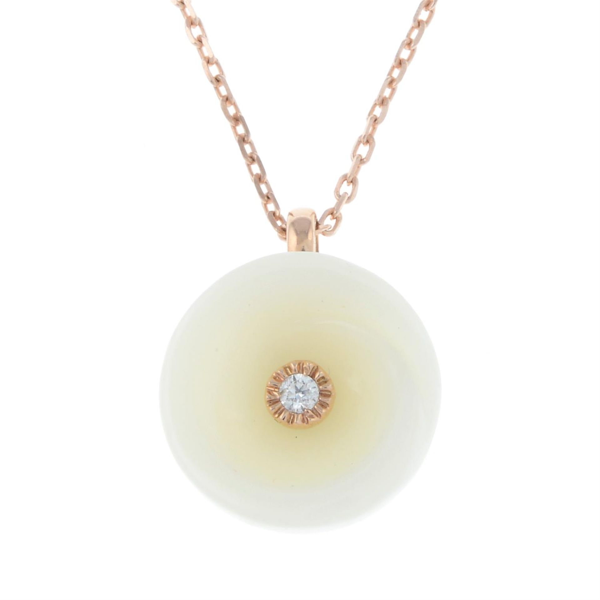 A jade and diamond floral pendant, with chain and free-moving cultured pearl pendant.