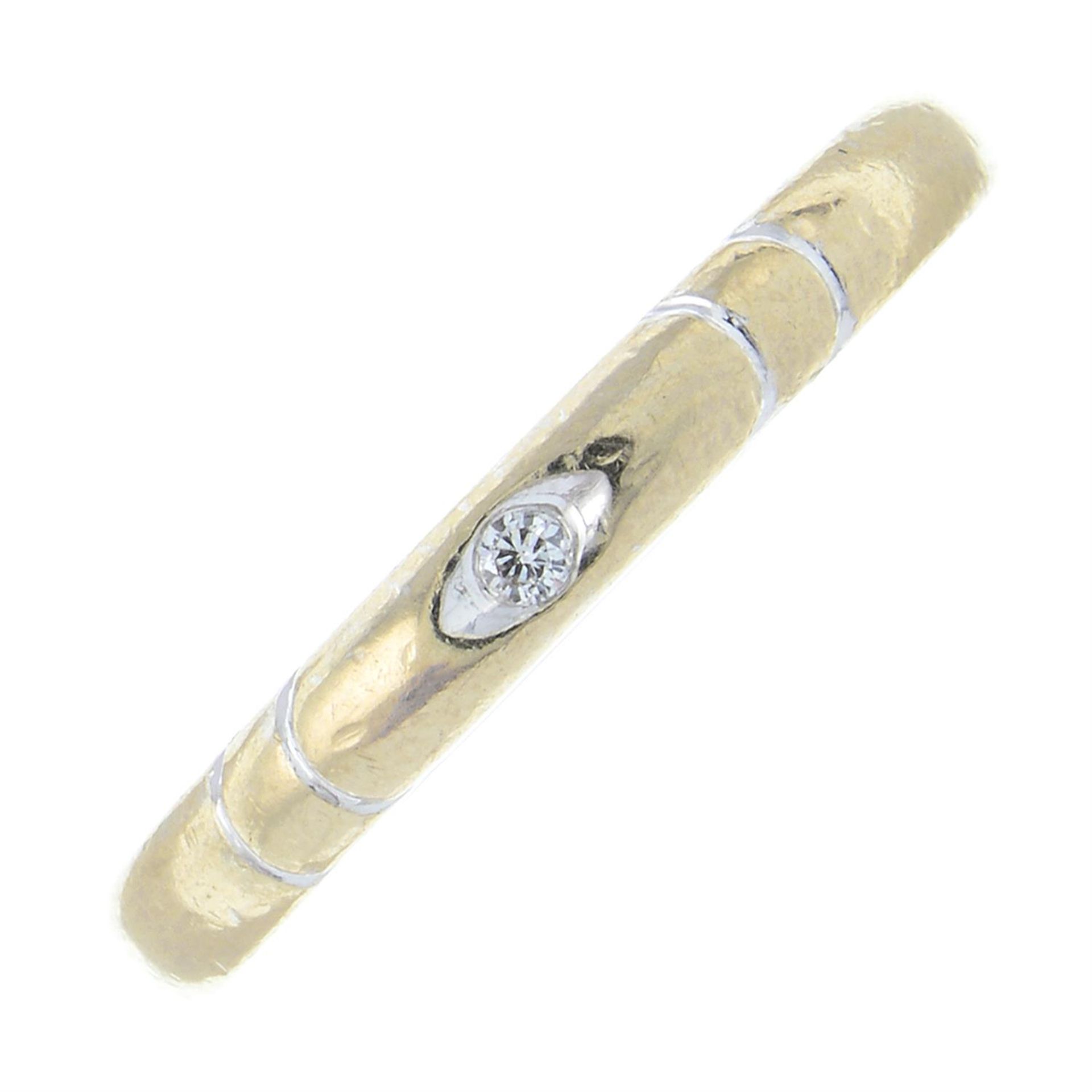 An 18ct gold diamond accent band ring.