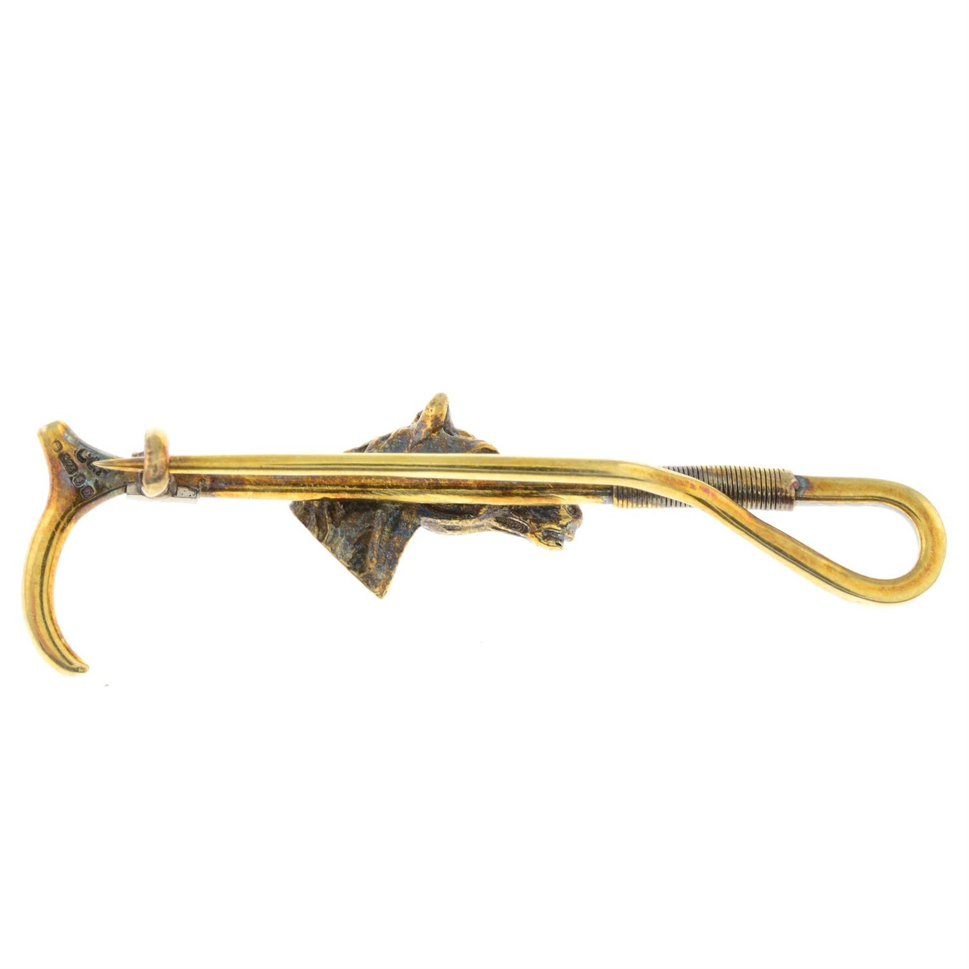 A 1970's 9ct gold horse and riding crop bar brooch, with ruby eye highlights. - Image 2 of 2