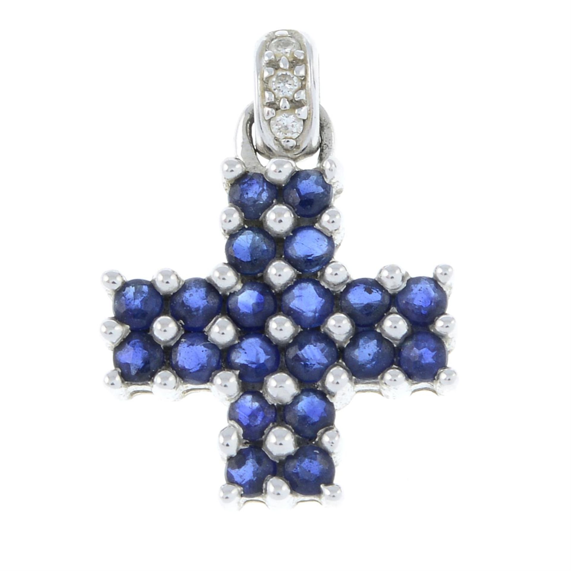 A vari-hue sapphire cross pendant, with diamond bale.