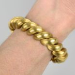 A 1960s textured 18ct gold bracelet, retailed by Kutchinsky.