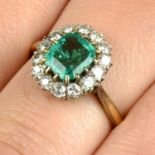 An emerald and brilliant-cut diamond cluster ring.