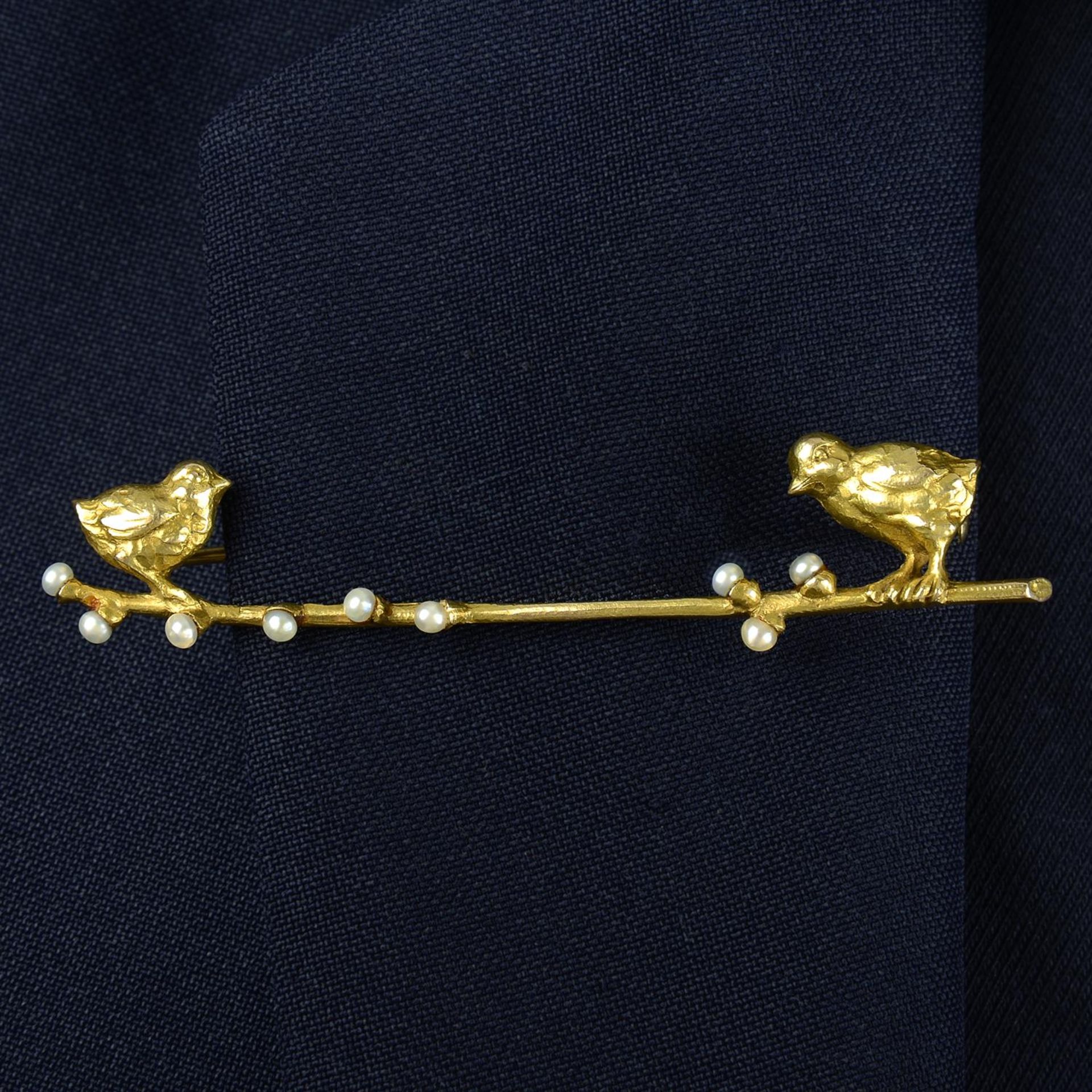 An early 20th century Austrian 14ct gold brooch, depicting two chicks upon a seed pearl budding
