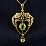 An Art Nouveau 15ct gold peridot foliate pendant.