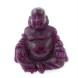 A carved ruby, weighing 66.63ct. Featuring Buddha