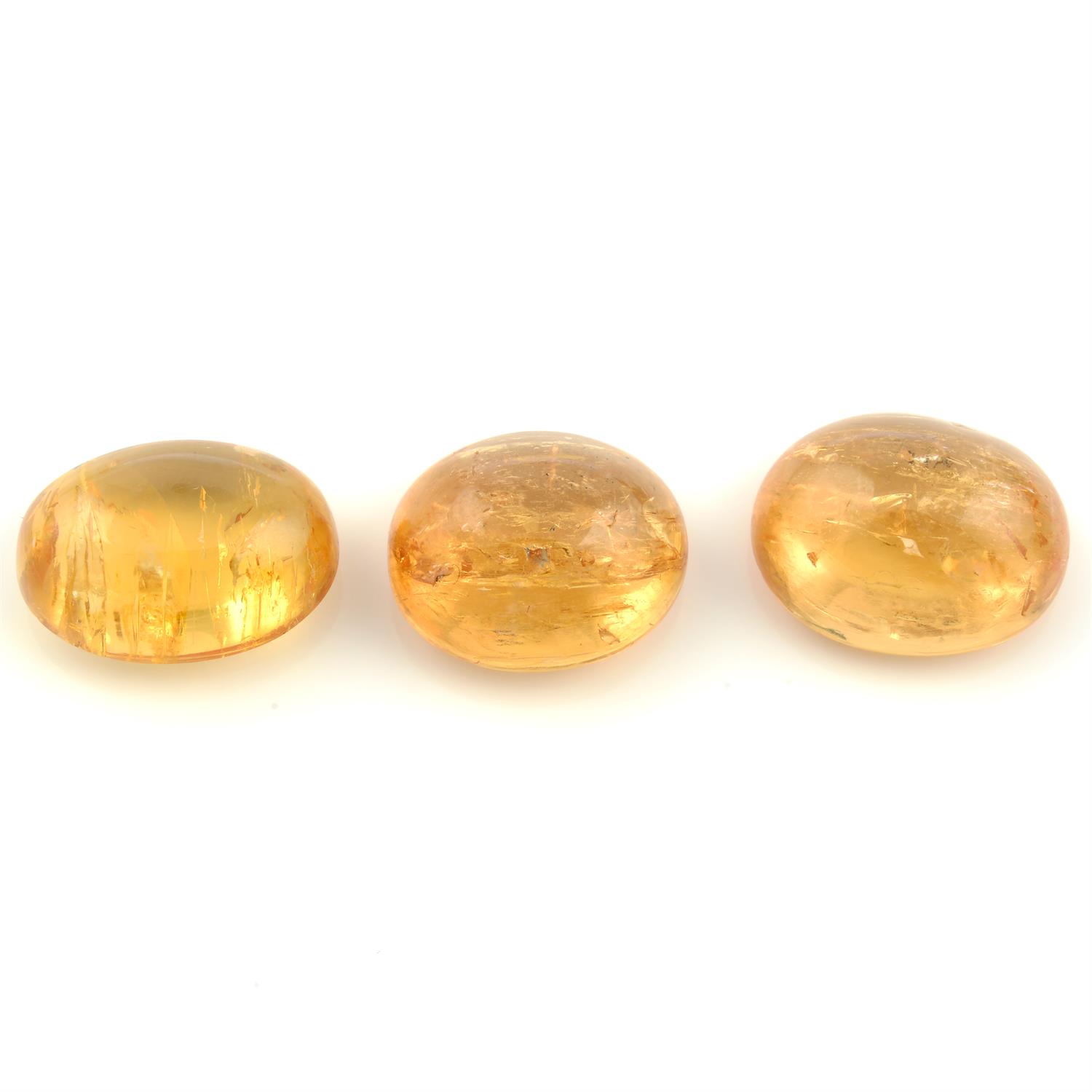 Three oval shape imperial topaz cabochons, weighing 28.97ct