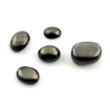 Sixteen oval shape black sapphire cabochons, weighing 39.20ct