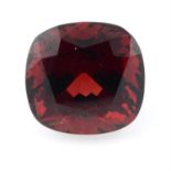 A cushion cut garnet weighing 14.22ct