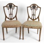 A pair of shield back dining room chairs.
