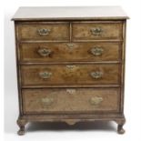 A walnut and mahogany veneered cross banded chest of drawers.