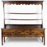 An antique oak and mahogany kitchen dresser.