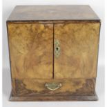 An early 20th century walnut smokers cabinet.