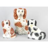 Five Staffordshire style pottery spaniels.