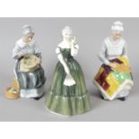 A selection of Doulton figurines.