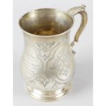 A mid-Victorian silver baluster mug with engraved decoration.