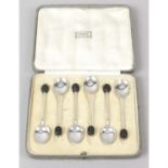 A selection of silver items to include cased coffee bean spoons, single candlestick (filled),