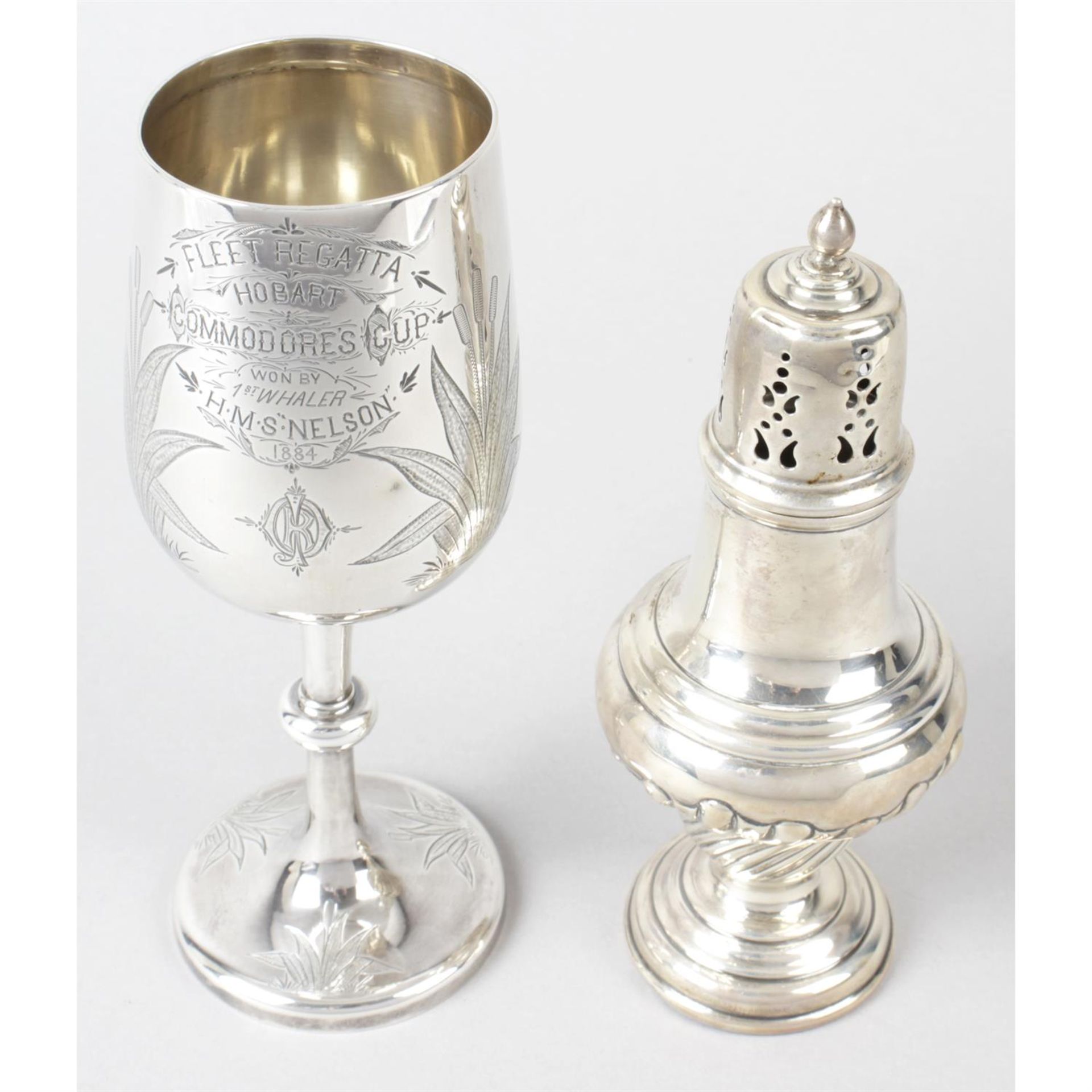 A mid-Victorian silver goblet, together with a late Victorian silver caster. (2).