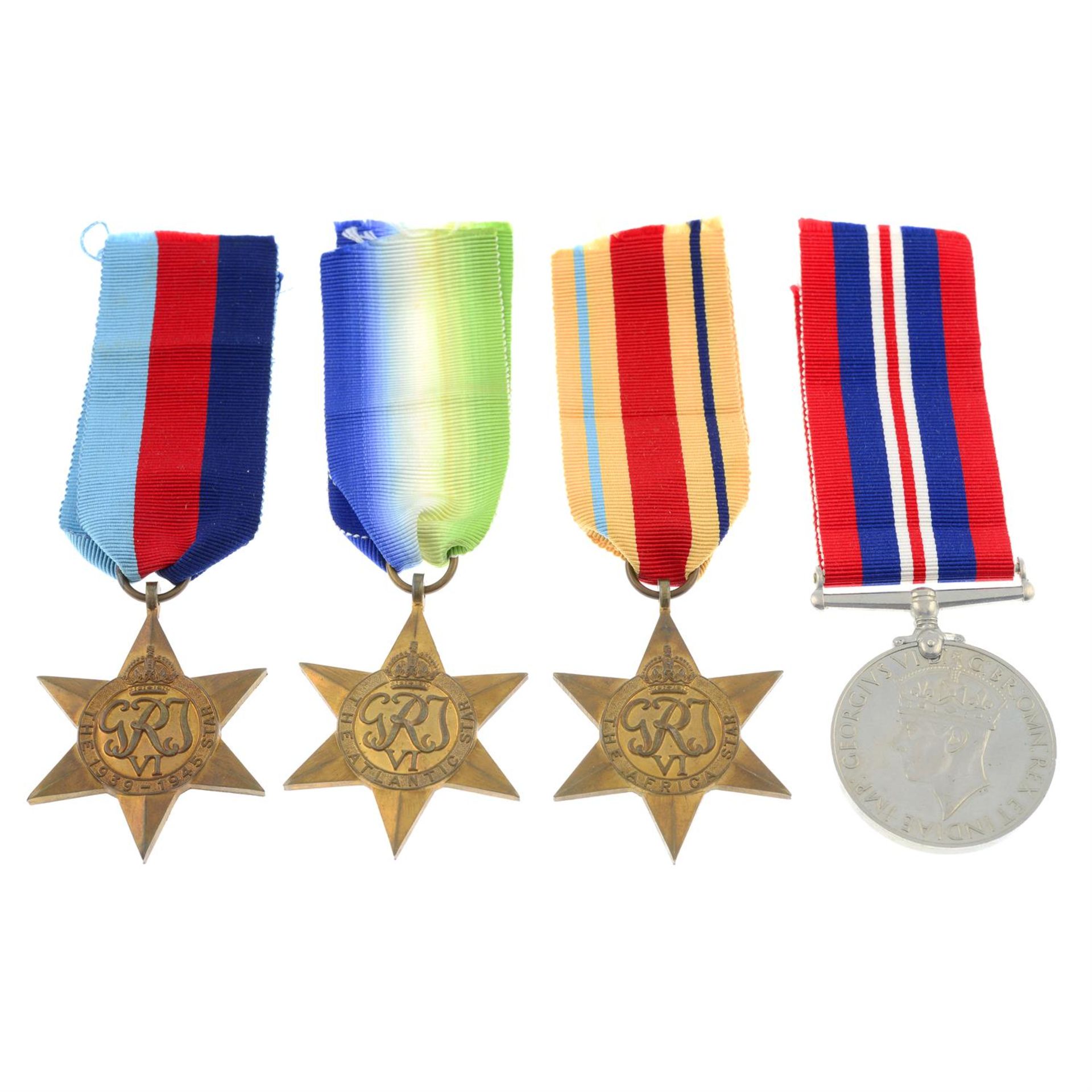 A group of four WWII medals with personal papers; together with another group of four with postage