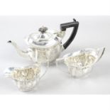 An Edwardian silver three piece bachelor tea set.